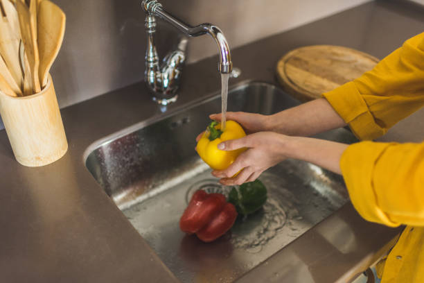 istock Woman Washing Red Pepper 875444542