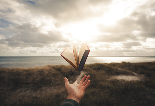 A picture of a levitating book above a hand. Picture taken by litteraly throwing the book in the air, the real magic was a fast shutter.