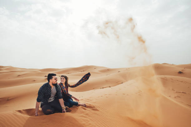 istock Loving couple in the Sahara Desert. Morocco. 875454104