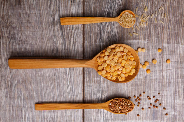 istock Three cereal filled wooden spoons on the table lie horizontally 875454636