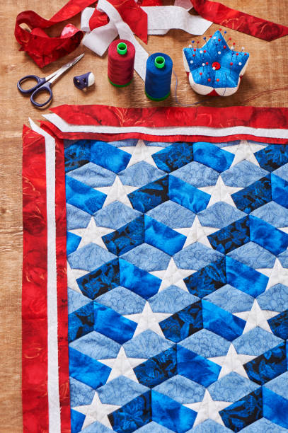 istock Sewing of quilt with stylized elements of American flag 875458102