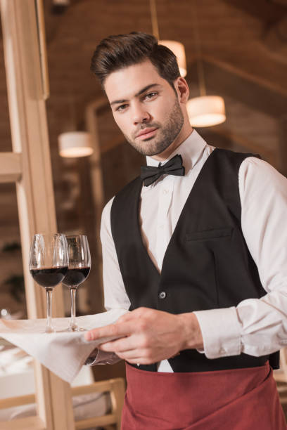istock waiter holding tray with wineglasses 875461316