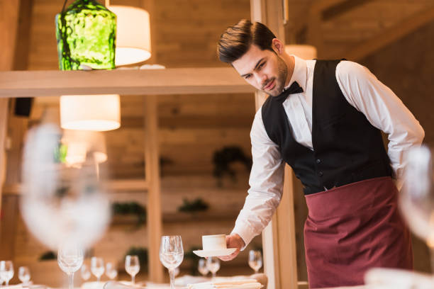 istock waiter serving cup of coffee 875463670