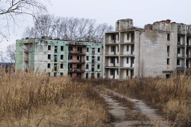 istock Old destroyed an abandoned multi-storey building in a military town 875466962