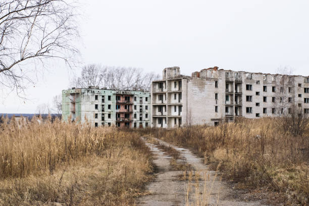 istock Old destroyed an abandoned multi-storey building in a military town 875467004