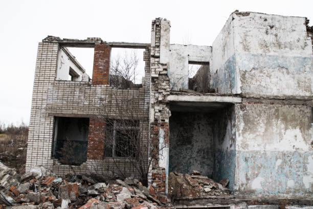 istock Old destroyed an abandoned multi-storey building in a military town 875467126