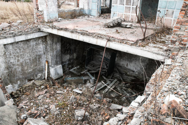 istock Old destroyed an abandoned multi-storey building in a military town 875467182