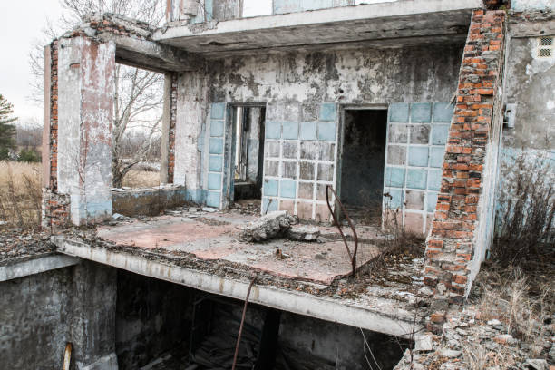 istock Old destroyed an abandoned multi-storey building in a military town 875467296