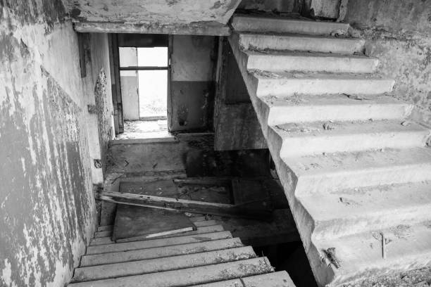 istock Old destroyed an abandoned multi-storey building in a military town 875467658