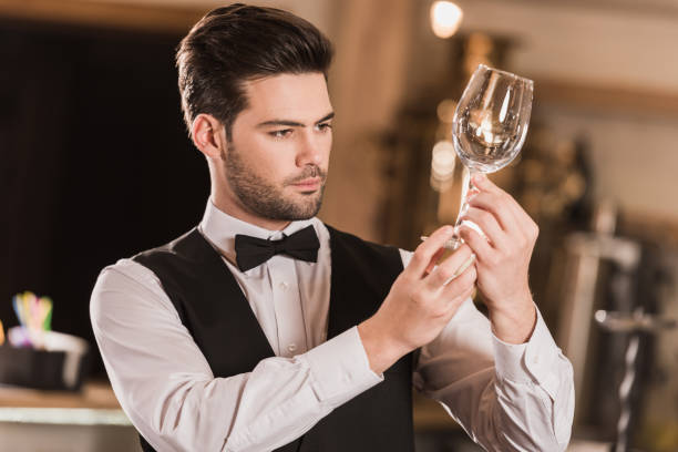 istock Bartender checking cleanness of wineglass 875470868