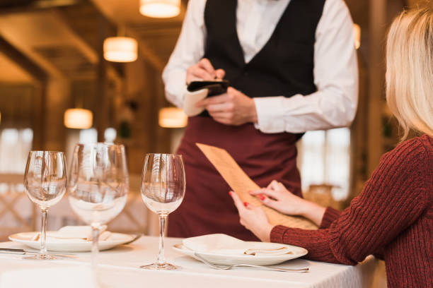istock Waiter writing down the order of customer 875471990