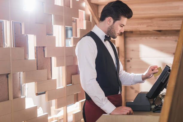 istock Waiter standing at cash register 875477958