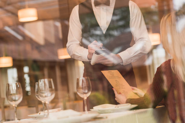 Waiter writing down the order of customer