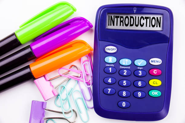 istock Introduction text in the office with surroundings such as marker, pen writing on calculator. Business concept for Firs Experience, starting white background with copy space 875483942