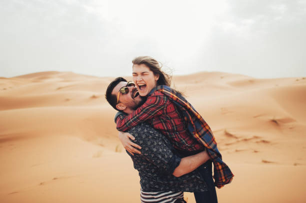 istock Loving couple in the Sahara Desert. Morocco. 875490402