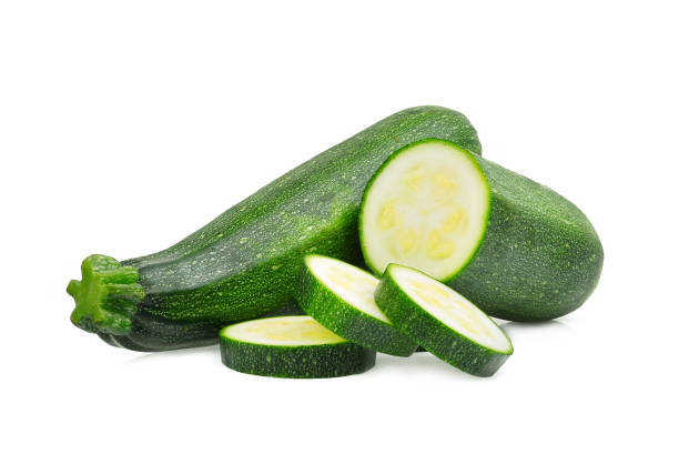 istock fresh green zucchini with slice isolated on white background 875490404