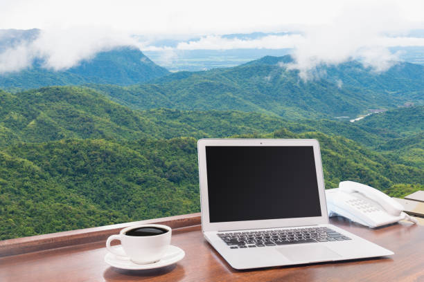 istock Laptops with white coffee mug on wooden desk 875496170