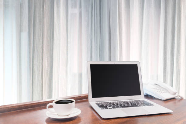 istock Laptops with white coffee mug on wooden desk 875496404