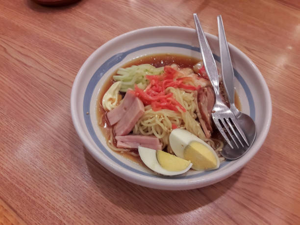 Japanese noodles in a cup on a table.