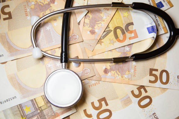 istock Stethoscope on euro money background 875502724