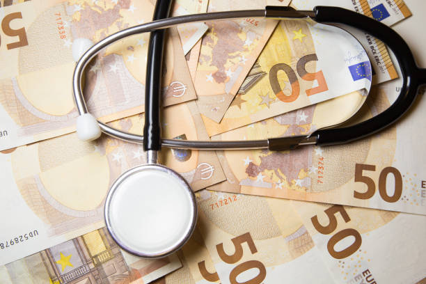 istock Stethoscope on euro money background 875502878