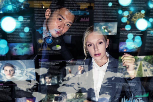 istock Two business persons in front of futuristic display. Graphical User Interface(GUI). Head up Display(HUD). Internet of things. 875503152
