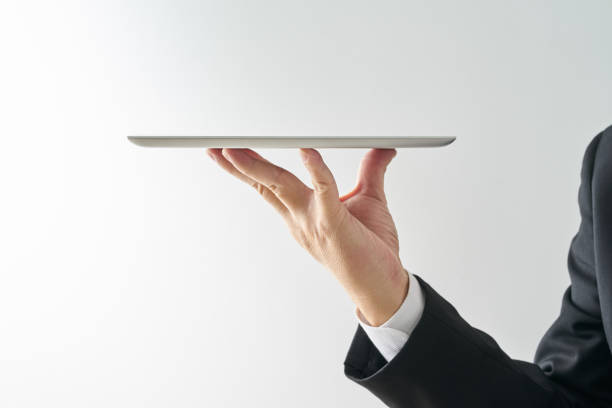 istock Waiter hand holding an empty digital tablet, Isolated on white background . concept of digital service . 875508238