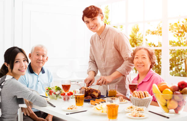 Happy asian family having dinner together Happy asian family having dinner together chinese ethnicity china restaurant eating stock pictures, royalty-free photos & images