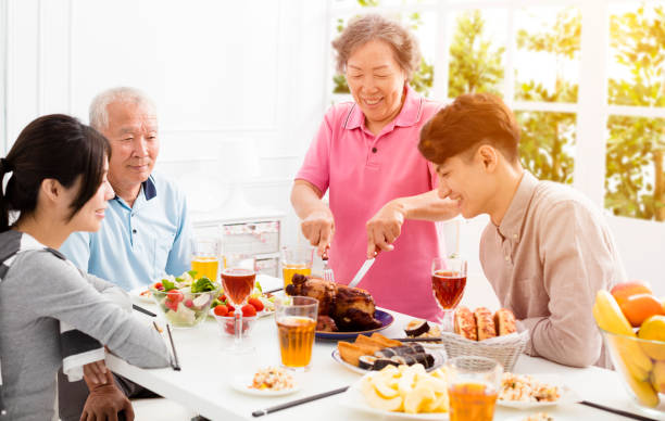 istock Happy family having dinner together 875508630