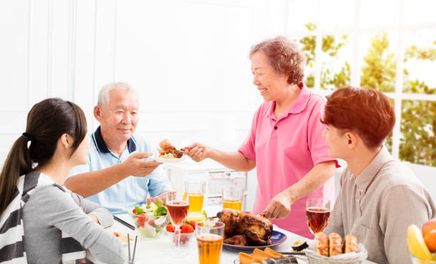 istock Happy asian family having dinner together 875508664