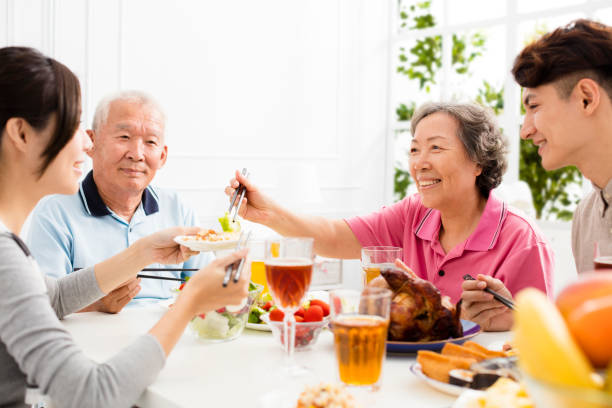 istock Happy family having dinner together 875508696