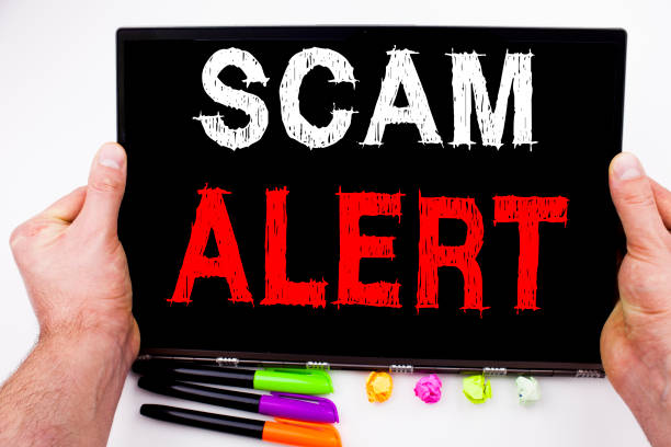 istock Scam Alert text written on tablet, computer in the office with marker, pen, stationery. Business concept for Scam Alert white background with copy space 875508966