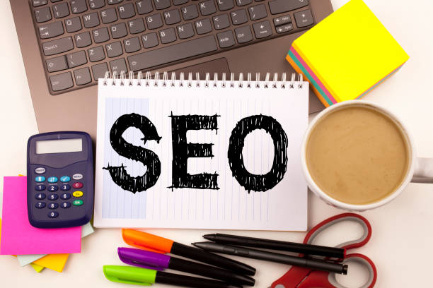 istock SEO Search Engine Optimization text in the office with surroundings such as laptop, marker, pen, stationery, coffee. Business concept for SEO white background with copy space 875514652