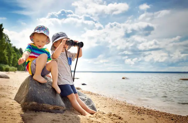 Photo of Babygirl and babyboy sitting on the beach