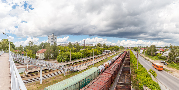 View of the railway station with three freight trains in city
