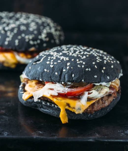 istock Black burger with meat and onion rings 875522108