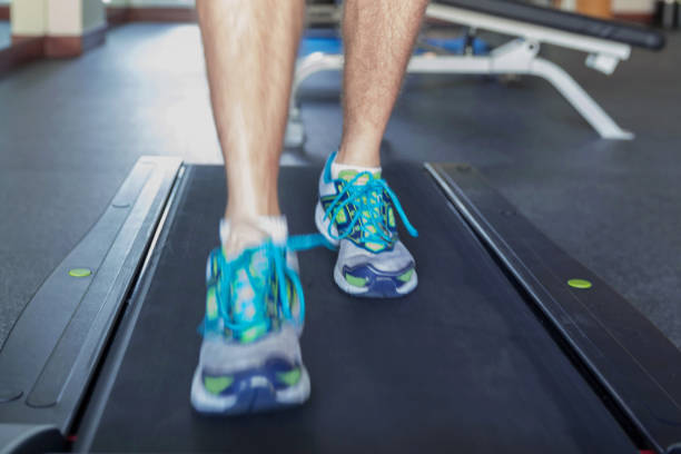 istock Adult men jogging in treadmill 875524922