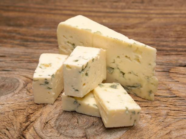 istock moldy blue cheese on wooden background 875530206