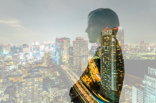 Double exposure of business person and cityscape.