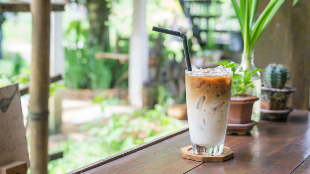 istock Iced latte on a wooden table in a cafe. 875541596