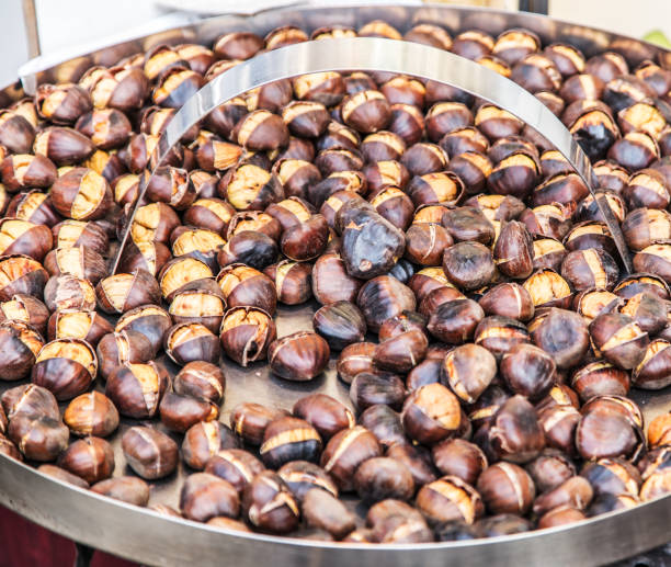 istock Fried chestnuts on the large metal tray. 875545000