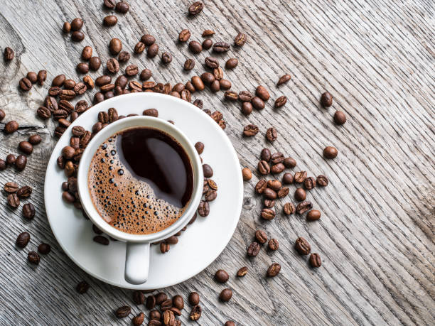istock Cup of coffee surrounded by coffee beans. Top view. 875545116