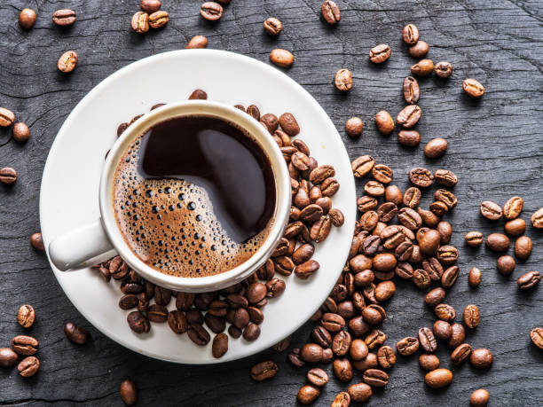 istock Cup of coffee surrounded by coffee beans. Top view. 875545158