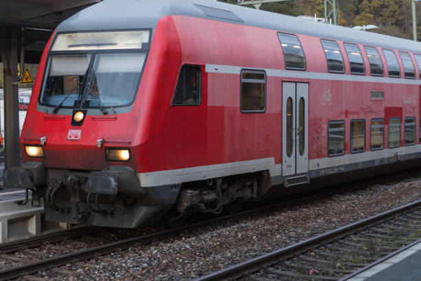 istock trainstation with train passing by and rails with infrastructure beside 875545250