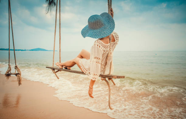 Woman sitting at tropical swing