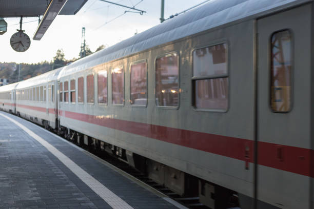 istock trainstation with train passing by and rails with infrastructure beside 875547506