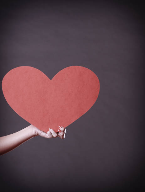 istock Girl holding big red heart in hands 875547844