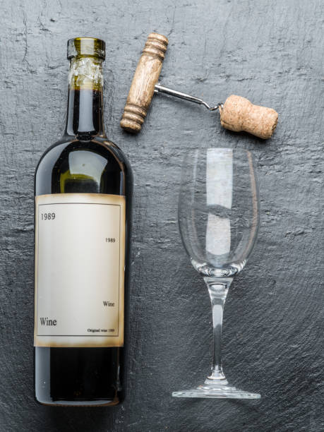 istock Wine bottle, wine glass and corkscrew on the graphite board. 875547864