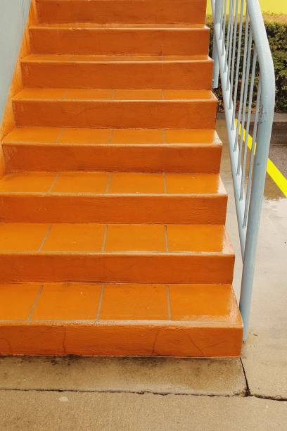 istock Orange colored stairs on outside of building. 875548024