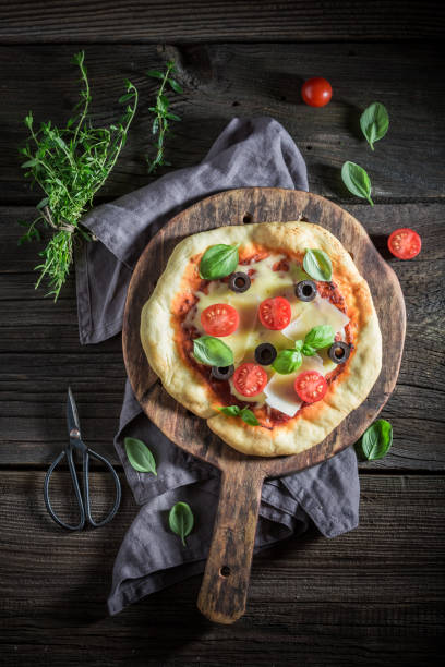 istock Yummy pizza made of cheese, tomatoes and herbs 875555006
